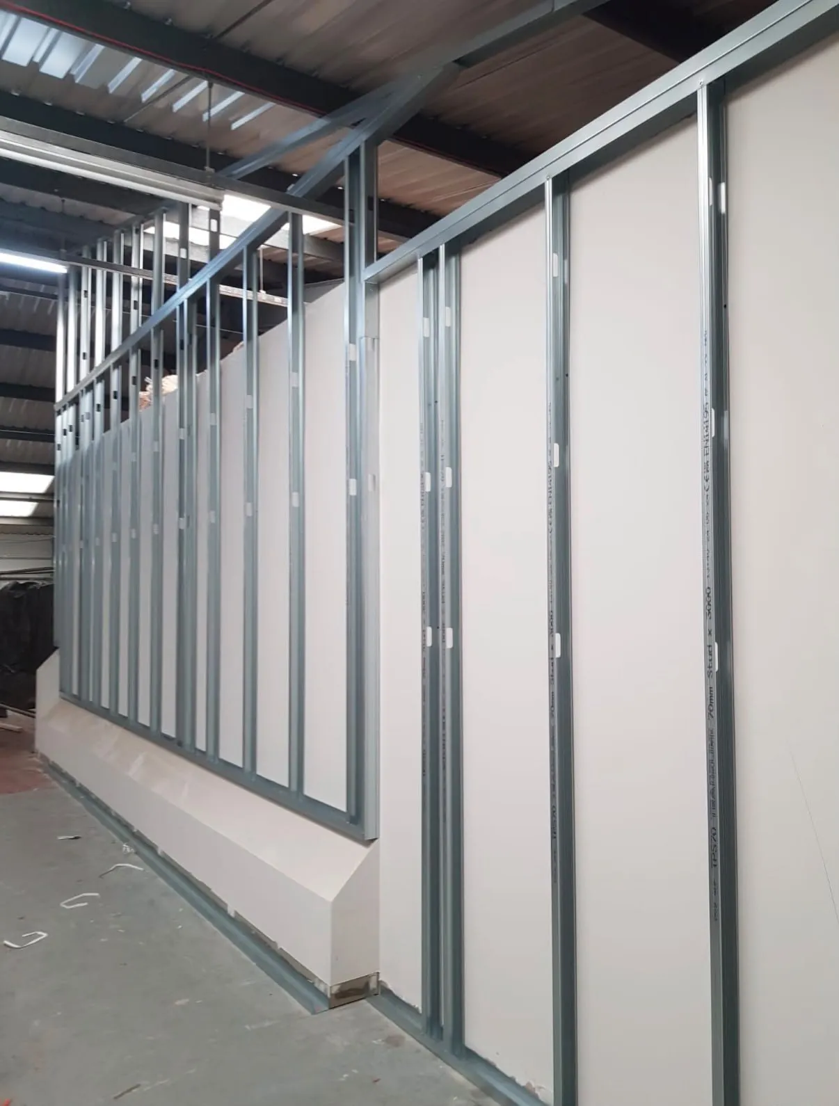 Metal stud partitions boarded on one side, with insulation going in between the studs