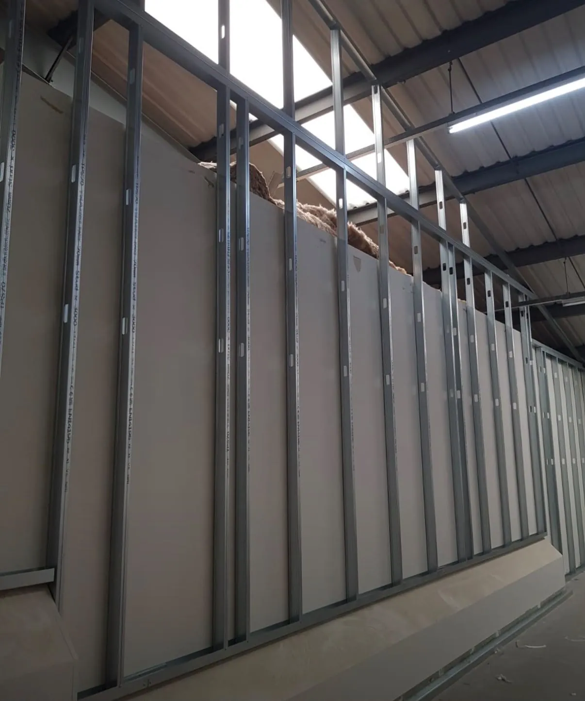 Row of 70mm galvanised metal studs at even centres, boarded on one side