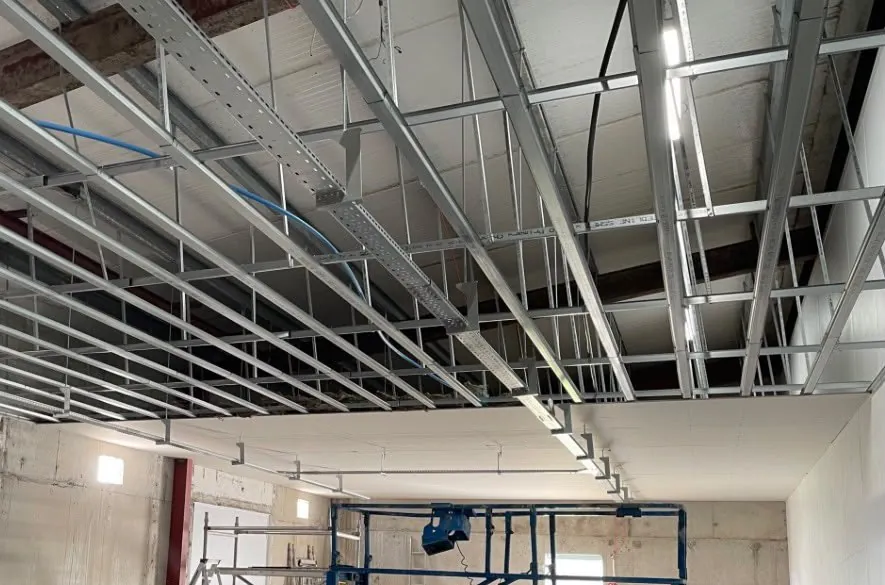 MF ceiling grid installed below a soffit, with cable tray running through