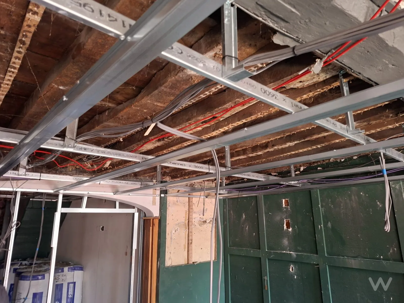 MF ceiling grid installed beneath original joists on a retail fit-out