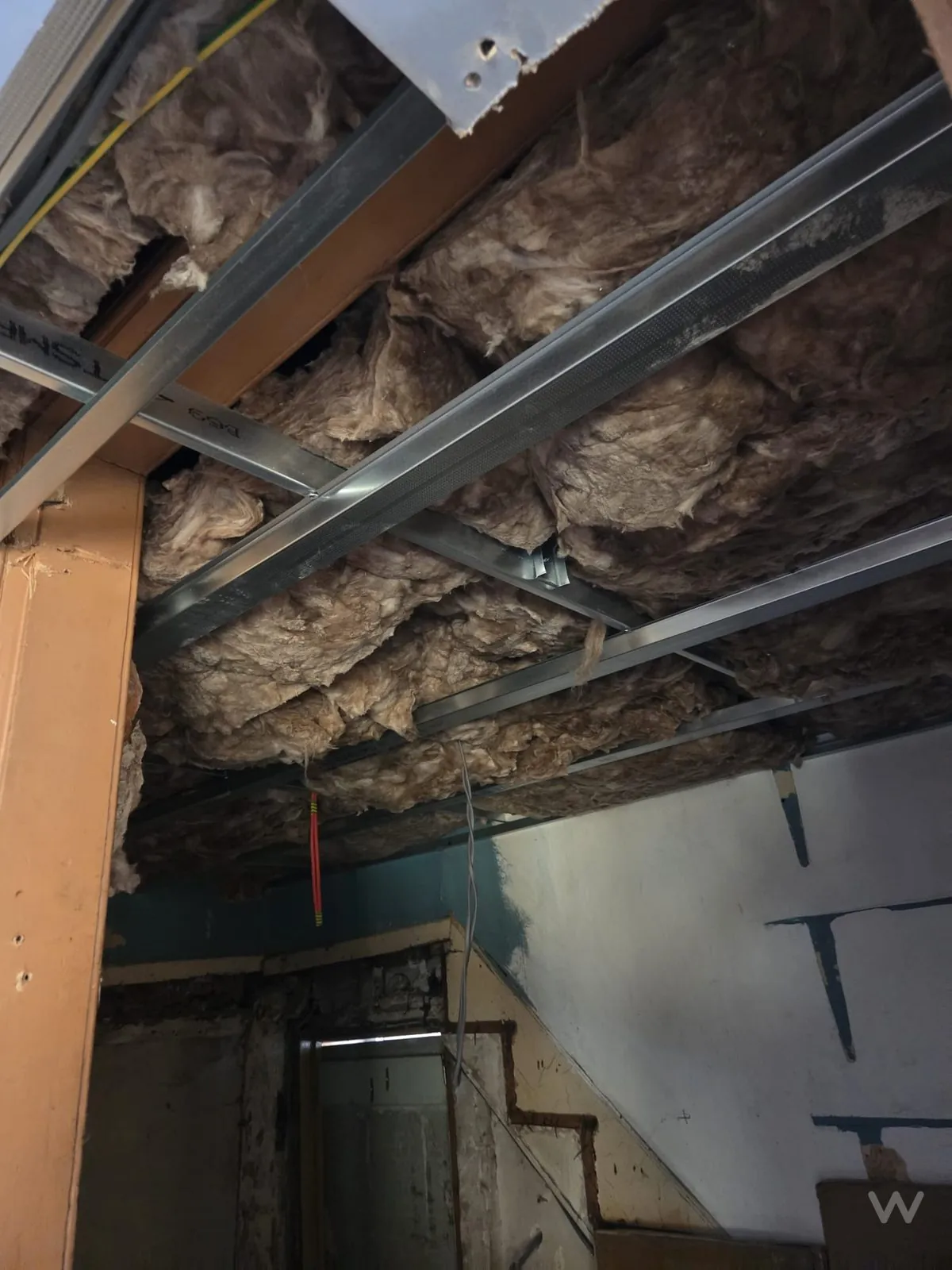 Mineral wool insulation installed within an MF ceiling build-up