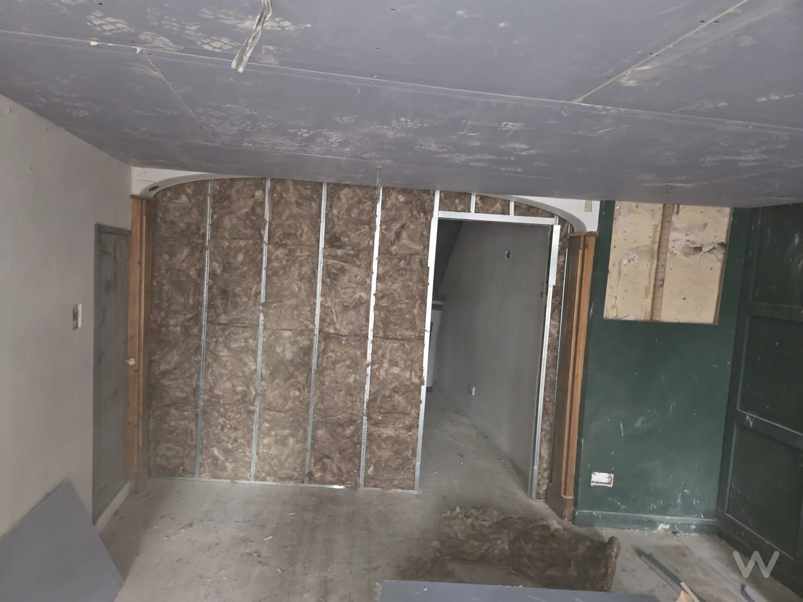 Curved metal stud partition fully insulated before boarding