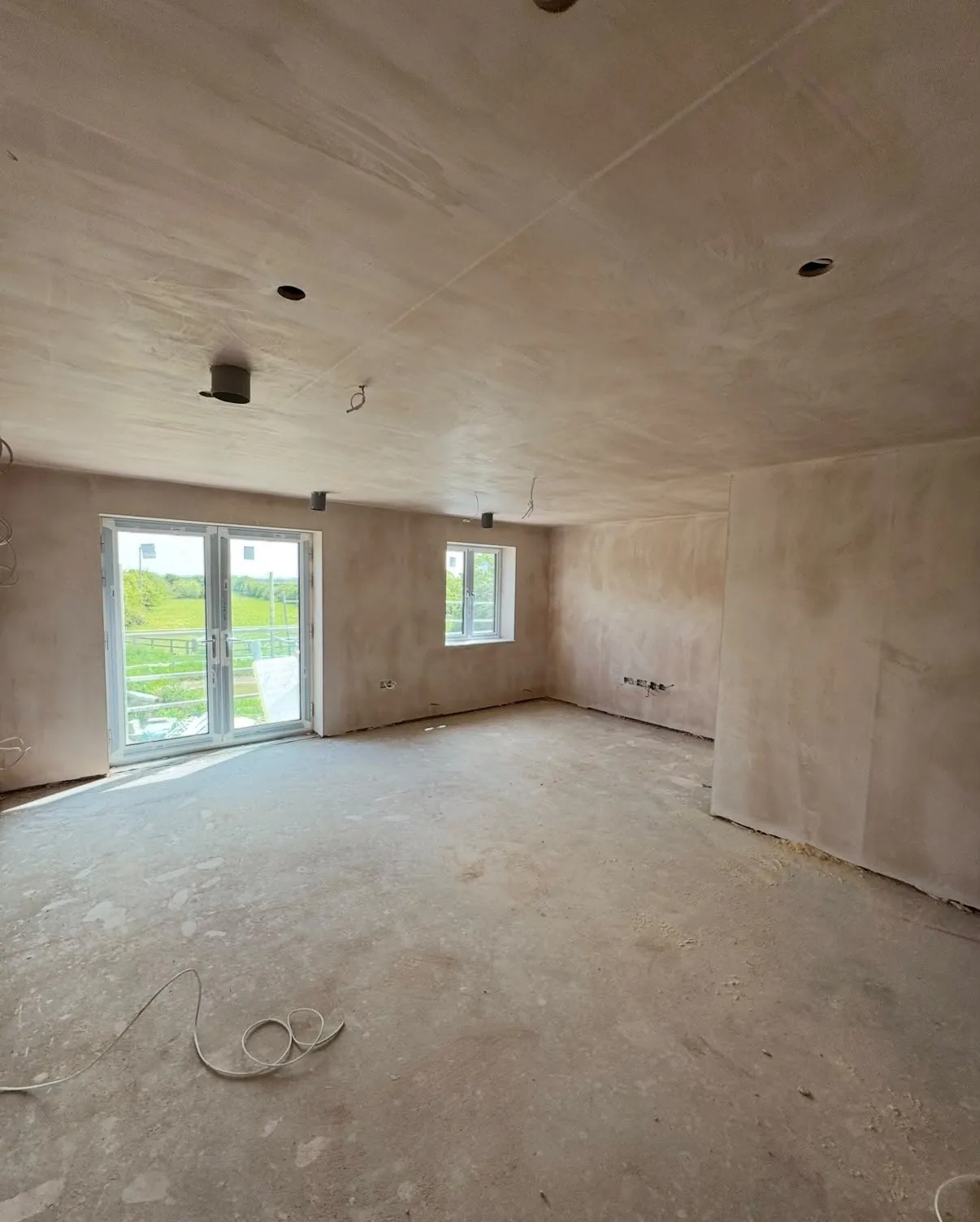 Plastered open-plan living room in a new-build flat, Swavesey, Cambridgeshire